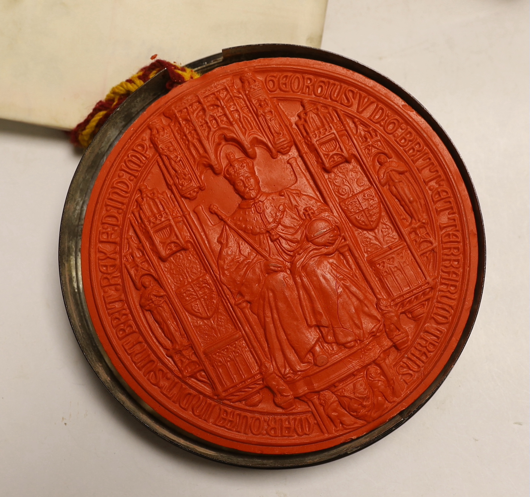 A cased George V Letters Patent related royal parchment document with large wax seal attached, seal separately encased within a tinned cylindrical case, seal 16cm diameter